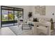 Comfortable living room featuring neutral tones, stylish decor, and large glass doors leading to an outdoor patio at 181 Pinewood Cir, Kissimmee, FL 34743