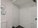Shower with marble-look walls and contrasting black hardware and floor at 181 Pinewood Cir, Kissimmee, FL 34743