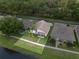 Overhead view of a well-maintained home with landscaped yard bordering a tranquil pond at 2244 Silver Lakes N Dr, Lakeland, FL 33810