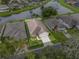 Aerial view of a desirable property with lush greenery, lake views, and a well-kept lawn at 2244 Silver Lakes N Dr, Lakeland, FL 33810