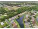 Scenic aerial view of homes along a canal with lush landscaping and a neighborhood with mature trees at 2244 Silver Lakes N Dr, Lakeland, FL 33810