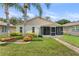 Home with well-maintained lawn, brick pathway, and a screened in patio at 2244 Silver Lakes N Dr, Lakeland, FL 33810