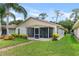 Back of house showing yard and screened patio, with brick pavers at 2244 Silver Lakes N Dr, Lakeland, FL 33810