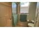 Well-lit bathroom with shower stall, commode, and decorative wallpaper accents at 2244 Silver Lakes N Dr, Lakeland, FL 33810