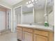 Bathroom showcasing light wood vanity, a large mirror, and doorways to other rooms at 2244 Silver Lakes N Dr, Lakeland, FL 33810