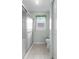 Bathroom with a shower, toilet, window, and tile floor at 2244 Silver Lakes N Dr, Lakeland, FL 33810