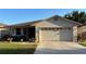 Charming single-story home with a well-manicured lawn, two-car garage and lovely curb appeal on a sunny day at 2244 Silver Lakes N Dr, Lakeland, FL 33810