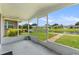 Screened lanai providing views of the manicured lawn and a serene pond at 2244 Silver Lakes N Dr, Lakeland, FL 33810
