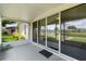 Screened lanai with view of the water, multiple glass doors, and outdoor rug at 2244 Silver Lakes N Dr, Lakeland, FL 33810