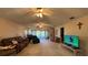Spacious living room with plush seating, fan, and sliding glass doors to enjoy natural light at 2244 Silver Lakes N Dr, Lakeland, FL 33810
