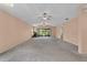Spacious living room with plush carpeting, ceiling fans, and large sliding doors with a water view at 2244 Silver Lakes N Dr, Lakeland, FL 33810