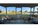 Relaxing screened lanai offers tranquil water views, seating and access to lush backyard at 2244 Silver Lakes N Dr, Lakeland, FL 33810