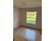 Bedroom featuring laminate floors, pink walls, and natural light from a window at 2342 Cilantro Dr, Orlando, FL 32837
