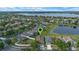 Aerial view of a residential area with a large lake in the background and a small pond nearby at 2407 Oakington St, Winter Garden, FL 34787