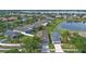 Aerial view of a single-Gathering home showing the driveway and landscaping near a pond at 2407 Oakington St, Winter Garden, FL 34787