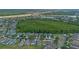 Aerial view of a residential neighborhood with houses, green spaces and a nature preserve at 2407 Oakington St, Winter Garden, FL 34787