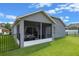 Back view of house with screened lanai, offering a private and comfortable outdoor living space at 2407 Oakington St, Winter Garden, FL 34787