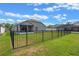 Spacious fenced backyard, perfect for outdoor activities, with a view of the screened lanai at 2407 Oakington St, Winter Garden, FL 34787