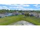 Expansive backyard features well-manicured lawns, screened-in patios, perimeter fencing and a serene pond, perfect for outdoor enjoyment at 2407 Oakington St, Winter Garden, FL 34787