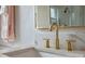 Elegant bathroom featuring a modern vanity, gold faucet, and stylish mirror at 2407 Oakington St, Winter Garden, FL 34787