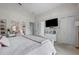 Comfortable bedroom with a TV, closet, and a vanity with clear shelves at 2407 Oakington St, Winter Garden, FL 34787