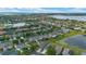 Lakeside community showcases a tranquil pond, verdant foliage, and single-Gathering homes, blending nature and residential living at 2407 Oakington St, Winter Garden, FL 34787
