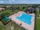 Aerial view of the community pool area, showcasing a large pool, hot tub, playground, and clubhouse at 2407 Oakington St, Winter Garden, FL 34787