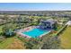 Community pool featuring a large swimming area, hot tub, and a nearby clubhouse at 2407 Oakington St, Winter Garden, FL 34787