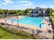 Community pool featuring a large swimming area, umbrellas, and a nearby clubhouse at 2407 Oakington St, Winter Garden, FL 34787