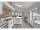 Bright kitchen with stainless steel appliances, white cabinets, and an open layout into the living area at 2407 Oakington St, Winter Garden, FL 34787