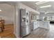 Well-lit kitchen with stainless steel appliances, white cabinets, and an open design into the dining area at 2407 Oakington St, Winter Garden, FL 34787