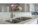Close up on a kitchen sink with a modern faucet and marble countertops at 2407 Oakington St, Winter Garden, FL 34787