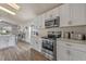 Kitchen with stainless steel appliances, white cabinets, and a view into the living space at 2407 Oakington St, Winter Garden, FL 34787