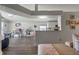 Living room with wood floors and an open layout showcasing the bar and kitchen area for seamless entertaining at 2407 Oakington St, Winter Garden, FL 34787