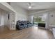 Spacious living room with hardwood floors, a fan, and a comfortable leather reclining couch at 2407 Oakington St, Winter Garden, FL 34787
