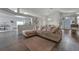 Bright living room with a large sectional sofa, wood floors, and vaulted ceilings for a spacious and airy feel at 2407 Oakington St, Winter Garden, FL 34787