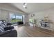 Comfortable living room featuring reclining chairs, an entertainment center, and a view of the lanai at 2407 Oakington St, Winter Garden, FL 34787
