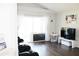 Bright living room with dark hardwood floors, entertainment center and sliding glass doors to the lanai at 2407 Oakington St, Winter Garden, FL 34787