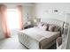Bright main bedroom featuring an upholstered bed, decorative wall art, and light pink curtains at 2407 Oakington St, Winter Garden, FL 34787