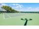 A green community tennis court under a clear blue sky at 2407 Oakington St, Winter Garden, FL 34787