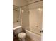 Bright bathroom with white tiled walls, toilet, and bathtub at 2516 Grassy Point Dr # 210, Lake Mary, FL 32746