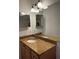 Bathroom vanity featuring a granite countertop, undermount sink, and bright lighting at 2516 Grassy Point Dr # 210, Lake Mary, FL 32746
