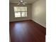 Bedroom with hardwood floors, a ceiling fan, and a window with natural light at 2516 Grassy Point Dr # 210, Lake Mary, FL 32746
