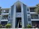 Exterior view of a blue and gray two-story building with an open stairwell and balconies at 2516 Grassy Point Dr # 210, Lake Mary, FL 32746
