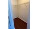 Walk-in closet with wood flooring and wire shelving for organized storage at 2516 Grassy Point Dr # 210, Lake Mary, FL 32746