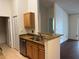 Kitchen view with wood cabinets, stainless steel appliances and granite countertops at 2516 Grassy Point Dr # 210, Lake Mary, FL 32746