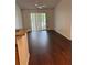Open living room with dining area and vinyl floors that lead to sliding glass door at 2516 Grassy Point Dr # 210, Lake Mary, FL 32746