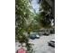 Exterior view of community pool with parking area, partially obstructed by tree branches at 2516 Grassy Point Dr # 210, Lake Mary, FL 32746