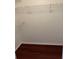 Walk-in closet with wood-look flooring, wire shelves, and ample space at 2516 Grassy Point Dr # 210, Lake Mary, FL 32746