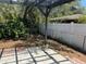 This backyard features an open patio area, gray pergola, and mixed fencing at 261 Deleon Rd, Debary, FL 32713